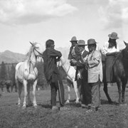 Cover image of Group of men speaking to Norman Luxton (at centre in a suit)